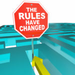 The Rules Have Changed Stop sign with puzzle maze game in background