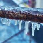 Many small icicles around freezing pipes